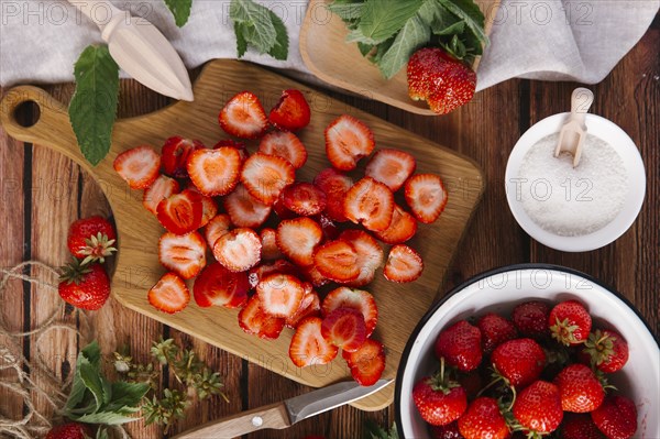 Close up of sliced strawberries on cutting board