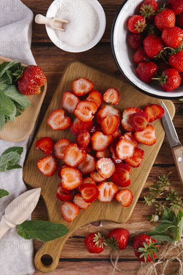 Close up of sliced strawberries on cutting board