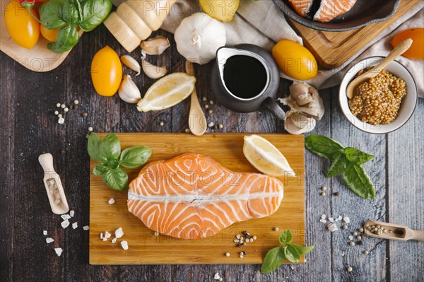 Raw salmon on cutting board with ingredients