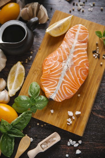 Raw salmon on cutting board with ingredients