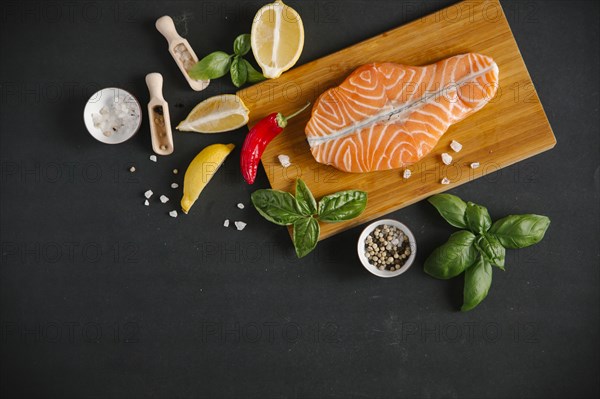 Raw salmon on cutting board with ingredients