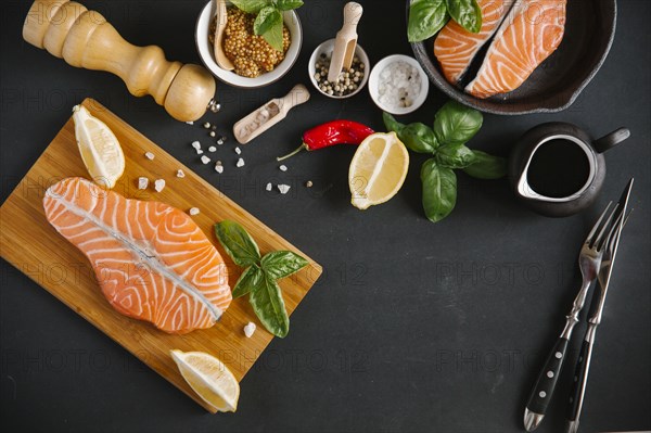 Raw salmon on cutting board with ingredients