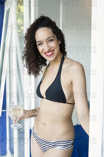 Mixed race woman smiling in bikini