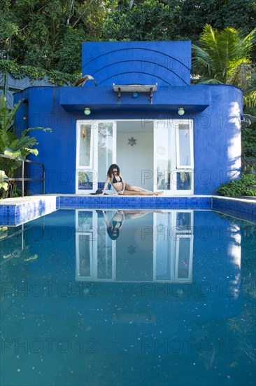 Mixed race woman reflected in swimming pool