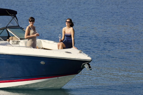 Women smiling on boat in ocean