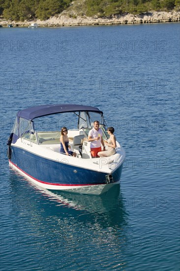 Friends relaxing on boat in ocean