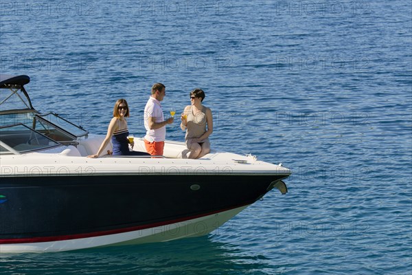 Friends relaxing on boat in ocean