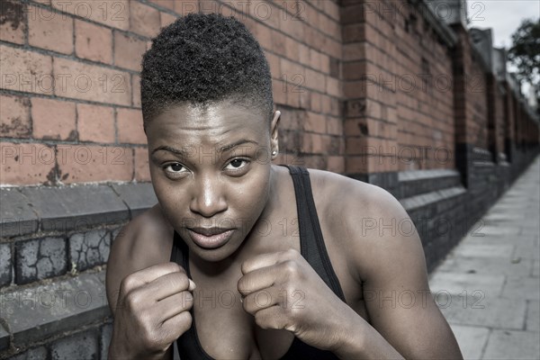 Black athlete with fists raised outdoors