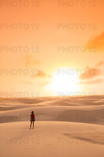 Mixed race teenage girl standing in remote desert