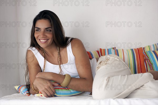 Smiling woman laying on bed