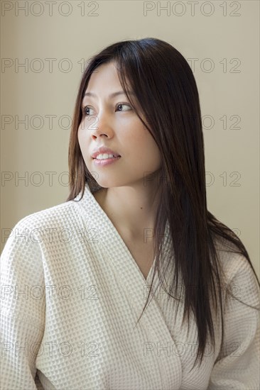 Woman wearing white robe looking away