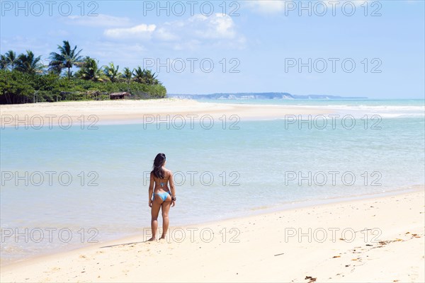 Mixed Race girl standing on beach