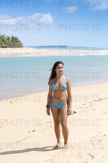 Mixed Race girl standing on beach