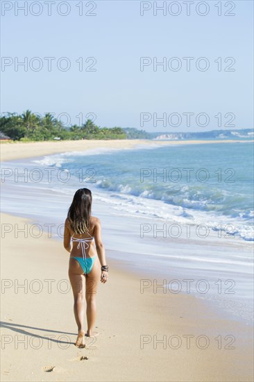 Mixed Race girl walking on beach