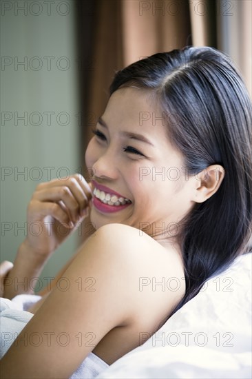 Portrait of laughing Asian teenage girl