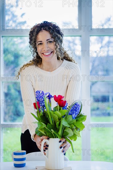 Woman holding vase with flowers