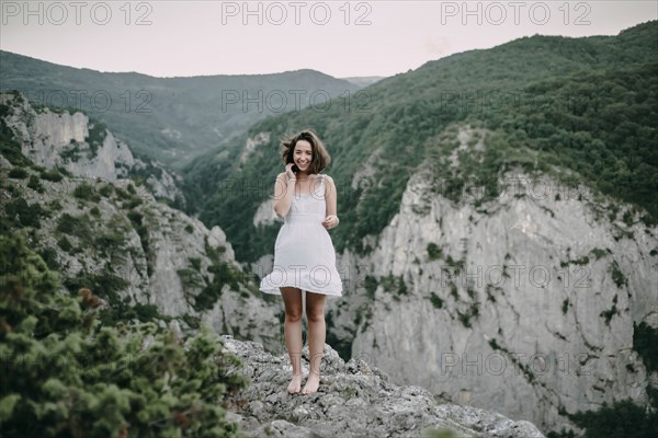 Smiling Caucasian woman standing on mountain