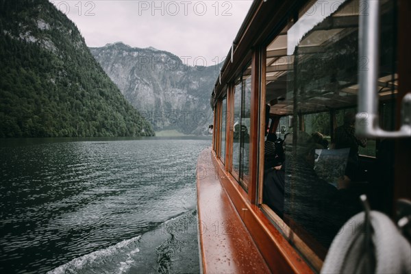 Close up of ferry on river near mountains