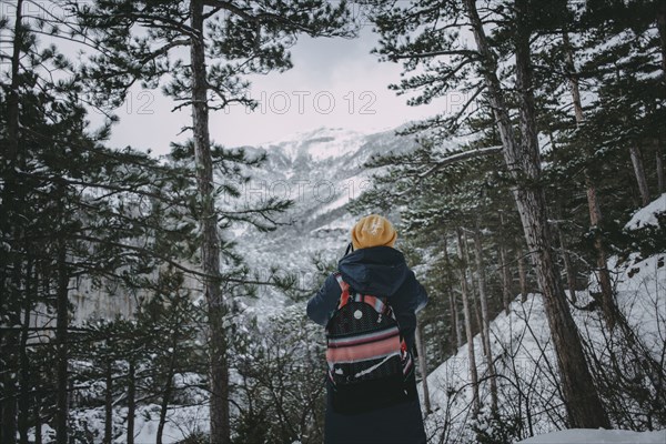 Caucasian woman admiring snowy forest