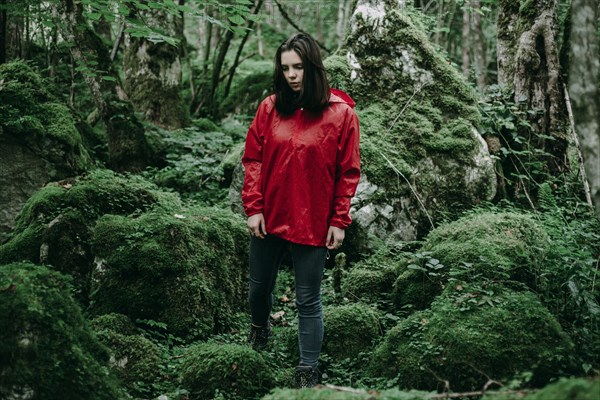 Caucasian woman standing in lush forest