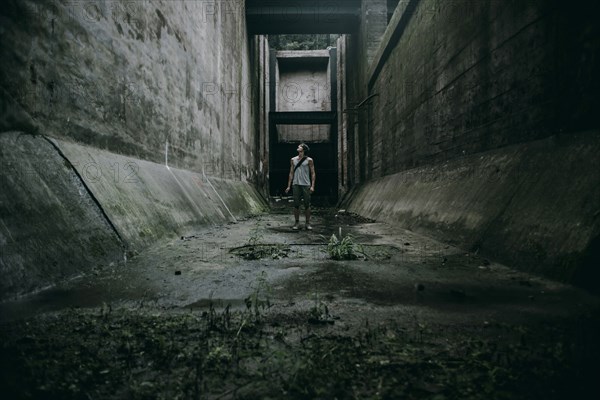 Caucasian man standing in concrete alley