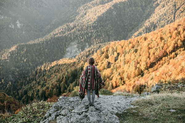 Caucasian woman standing on mountain overlooking valley