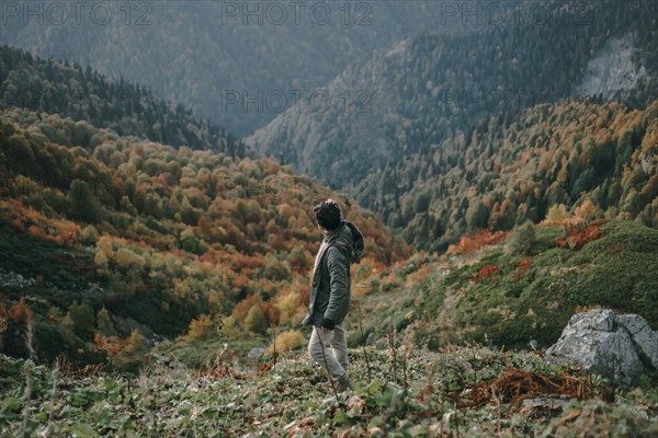 Caucasian man walking in valley