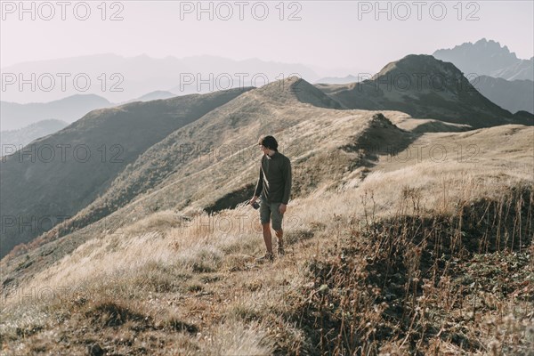 Caucasian man hiking on mountain