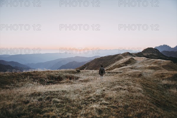 Caucasian man hiking in remote mountain landscape