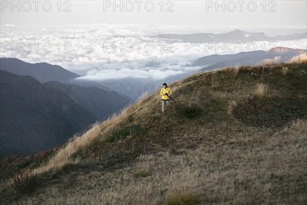 Caucasian man standing in remote mountain landscape