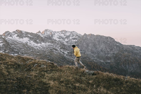 Caucasian man hiking in remote mountain landscape