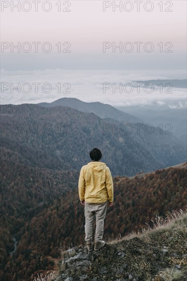 Caucasian man standing in remote mountain landscape