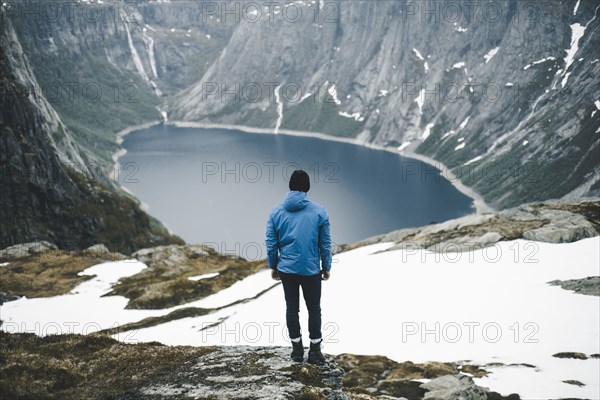 Caucasian man admiring scenic view of mountain lake