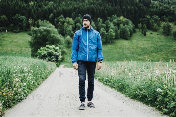 Caucasian man standing on dirt path