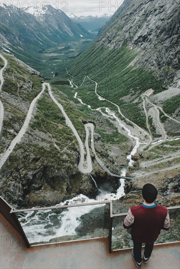 Caucasian man standing at  viewpoint admiring scenic view of valley