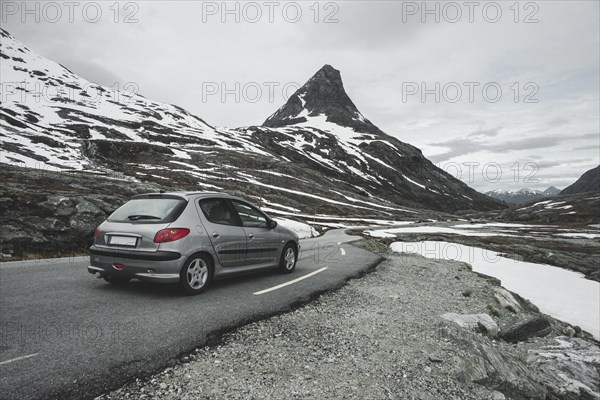 Car driving on road in winter landscape