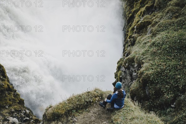 Caucasian woman watching waterfall