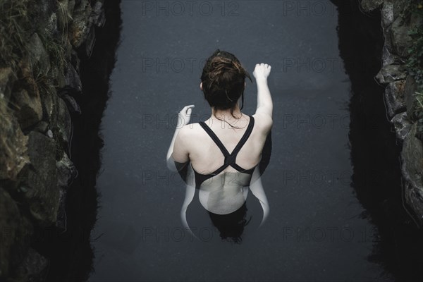 Caucasian woman swimming in pond