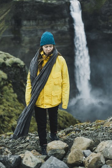 Caucasian woman walking near waterfall
