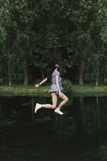 Caucasian woman floating over lake