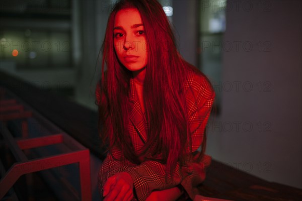 Serious Caucasian woman wearing jacket at night