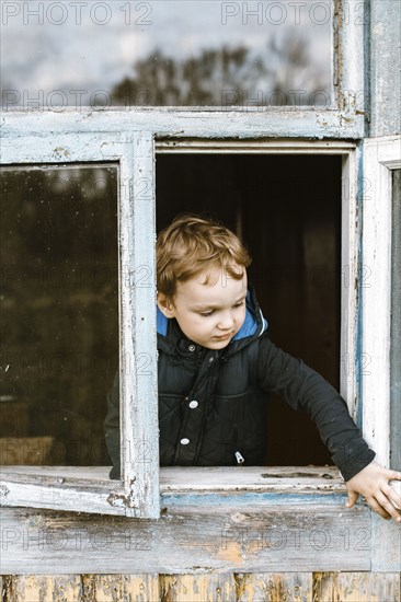 Caucasian boy opening window