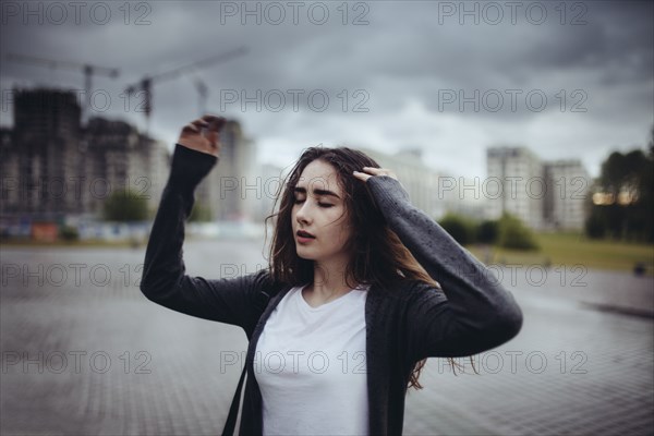 Caucasian woman dancing outdoors