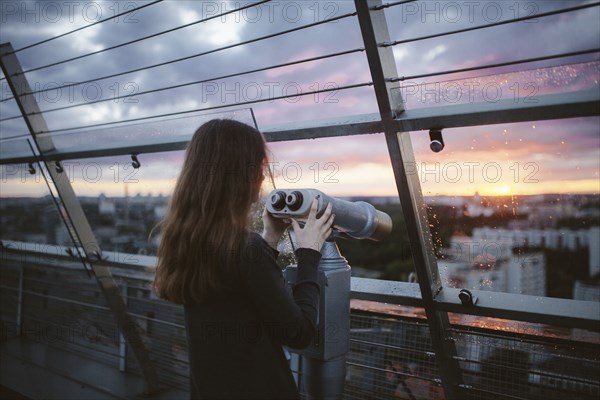 Curious Caucasian admiring scenic view with binoculars