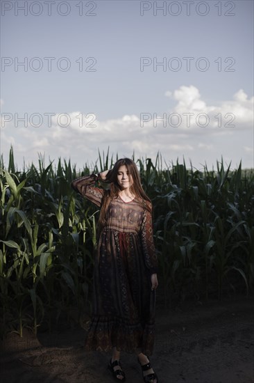 Caucasian woman standing in cornfield