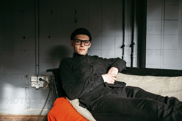 Portrait of serious Caucasian man on sofa