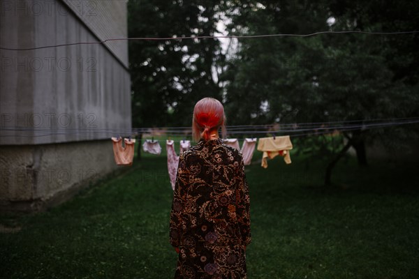 Caucasian woman staring at clothesline