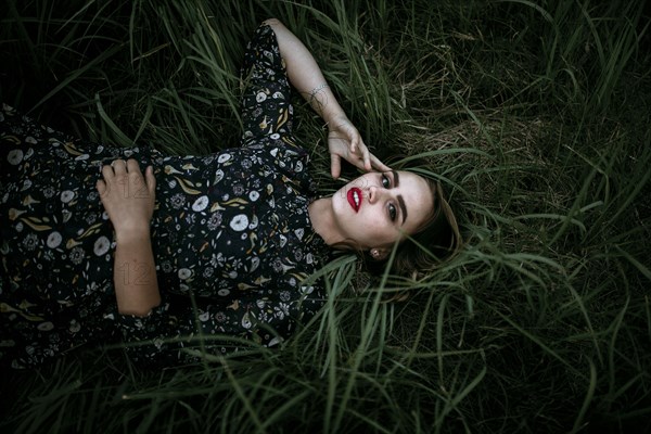 Caucasian woman laying in grass