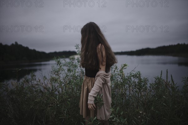 Caucasian woman standing near river