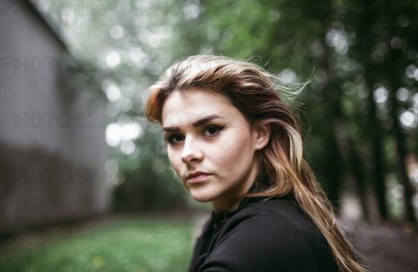 Wind blowing hair of serious Caucasian woman